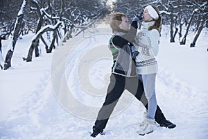 Romantic photo of cute couple outdoors in winter. Young man and