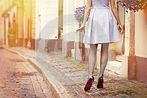 Romantic photo of woman walking in old town