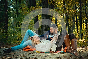 Romantic picnic forest. Couple in love tourists relaxing on picnic blanket. Romantic date in nature. Tourism concept