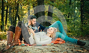 Romantic picnic forest. Couple in love tourists relaxing on picnic blanket. Romantic date in nature. Only two of us an