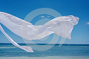 Romantic place by the sea. White fabric curtains fluttering in the wind.