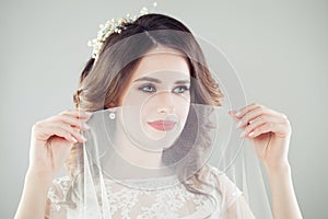 Romantic portrait of beautiful bride with makeup, bridal hairstyle and veil