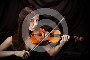 Romantic portrait of beautiful woman with violin