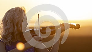 Romantic portrait of girl playing violin at sunset in field, woman relaxing in music, performance on nature, concept art and hobby