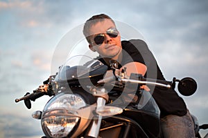 Romantic portrait handsome biker man in sunglasses