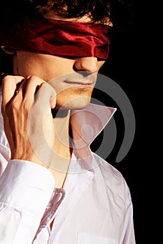 Romantic portrait of a handsome blindfold man