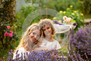 Romantic portrait o charming girl in straw hat in lavender