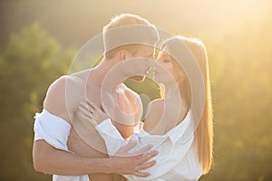 Romantic portrait of a sensual couple in love. Passionate man kissing sensual woman. Embrace and kiss. Sensual kiss, Man