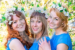 Romantic portrait of three women at the time of flowering cherry