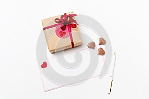 Romantic present gift box, white blank greeting card with pen and heart-shaped chocolate candies