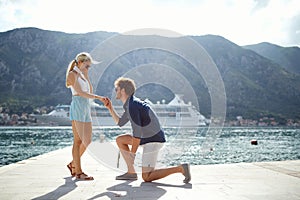Romantic proposal on the lake. man proposal his girl on vacation