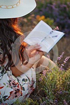 Romantic reading woman with book on lavender field