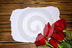 Romantic red roses flowers on a vintage wooden planks background.