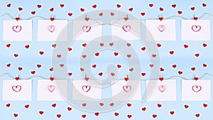 Romantic red valentine hearts on pastel blue theme. Stop motionValentine love hearts on papers hooked on rope. Stop motion