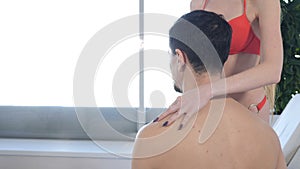 Romantic relationships, passion and wellness concept. Young caucasian couple in spa centre. Back view. Unrecognizable