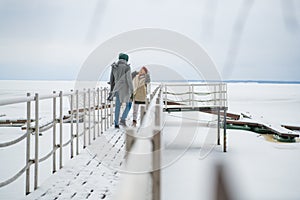 Romantic rendezvous of two lovers on valentine& x27;s day on a pier on a frozen river