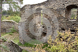 romantic ruins of GutÃÂ¡tejn Castle are located on a rocky watchtower above the forested valley of the Hadovka photo