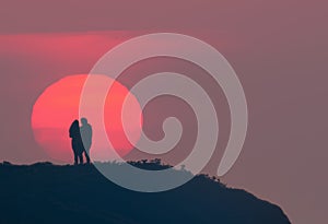 romantic scene of a couple watching the sunset