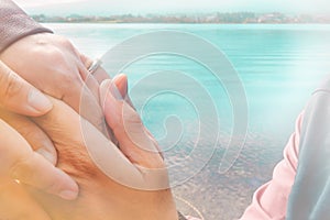 Romantic scene happy hands of lovers while The young man asked the woman to marry and wear an engagement ring for wedding and