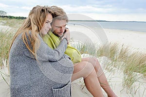 Romantic seaside lovely couple in sand dune - autumn, beach