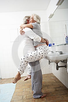 Romantic Senior Couple In Bathroom