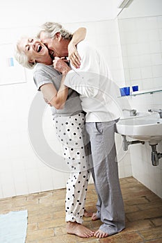 Romantic Senior Couple In Bathroom