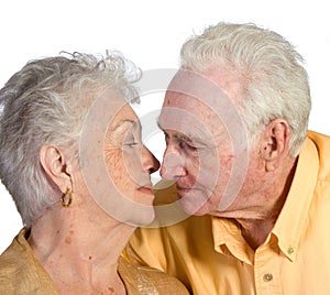 Romantic senior couple embracing to kiss