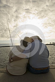 Romantic Senior Couple Fishing At The Beach