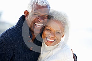 Romantic Senior Couple Hugging On Beach