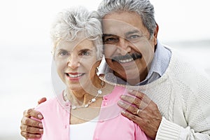 Romantic Senior Couple Hugging On Beach