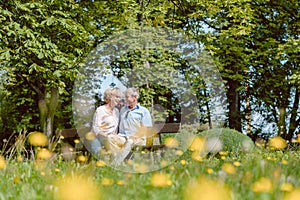 Romantic senior couple in love dating outdoors in an idyllic par