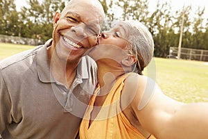 Romantic Senior Couple Taking Selfie In Park
