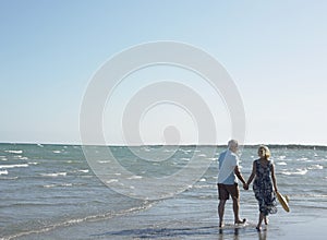 Romantic Senior Couple Walking On Beach