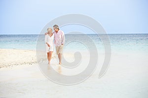 Romantic Senior Couple Walking On Beautiful Tropical Beach