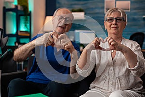 Romantic senior family creating heart shape symbol