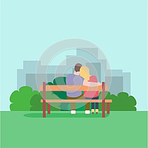 Romantic silhouette of loving couple sit on a bench in park