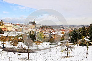 Romantic snowy colorful autumn Prague with gothic Castle