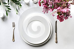 Romantic spring table setting with apple tree flowers on white table. Top view