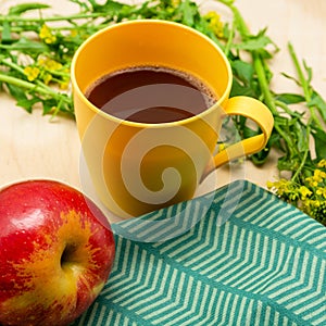 Romantic summer breakfast. On the table are coffee, apple, bun and napkin.