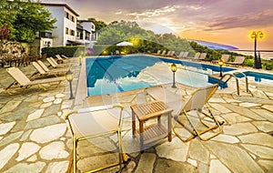 Romantic sunrise over the house and swimming pools photo