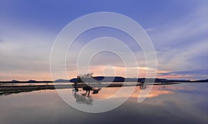 Romantic sunset with countryside, Thai big fish trap common name Yor reflextion on the lake with cloudy sky in twilight time