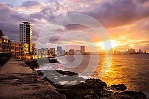 Romantic sunset at the Malecon seawall in Havana photo