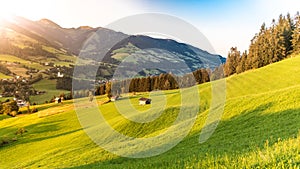 Romantic sunset in the mountains. Green alpine meadows and high peaks of Austrian Alps. Salzach River Valley, Pinzgau