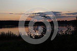 Romantic sunset over the lake. Sun hidden in the clouds. Olesna Dam in the Czech Republic.