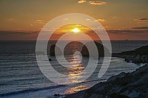 Romantic sunset over a rocky beach at Cyprus