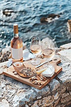 Romantic Sunset Picnic by the Sea With RosÃ© Wine and Fresh Grapes