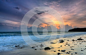 Romantic sunset at a rocky beach