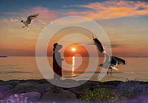 Women  sunset  in red dress and summer hat seagull fly enjoy pink summer sunset at sea nature seascape  landscape  romantic