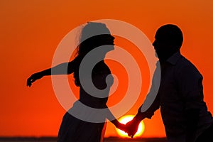 Romantic sunset and silhouettes of lovers