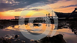 romantic sunset at untia beach, a recommended tourist attraction when you visit Makassar, South Sulawesi province, Indonesia. photo